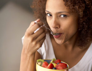 woman eating strawberries