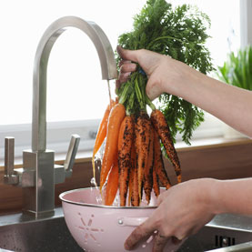 bunch carrots being washed