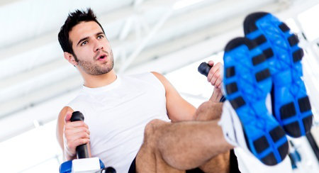 man on rowing machine at gym