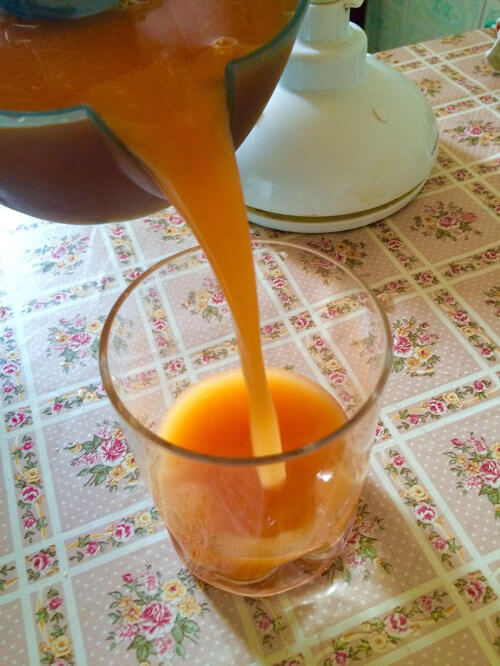 pouring carrot juice