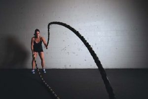 woman in gym with ropes