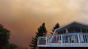 smoky skies house people on porch