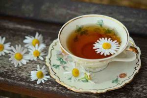 tea cup with tea and flowers