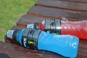 bottle of red powerade and bottle of blue powerade