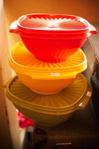 three tupperware bowls red orange and yellow