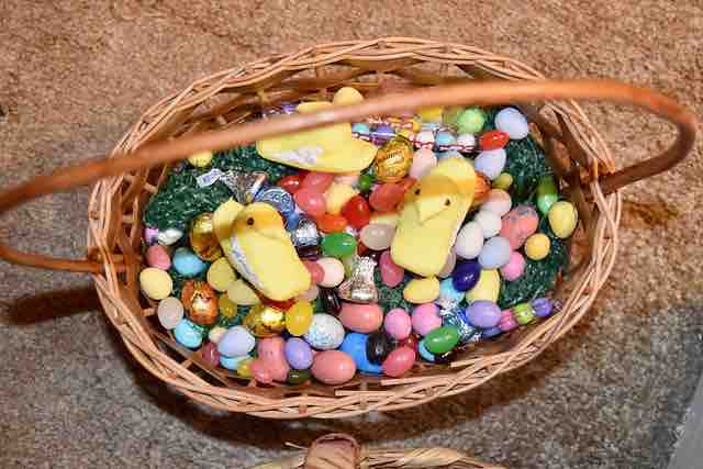 basket with sugar candies and plastic grass