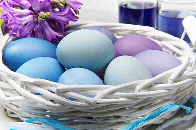 white wicker basket with naturally dyed blue eggs